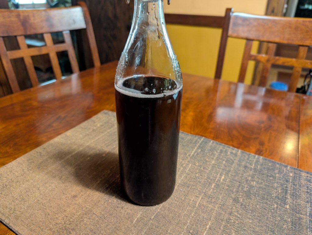 Sekanjabin made with stale red wine in a clear glass bottle