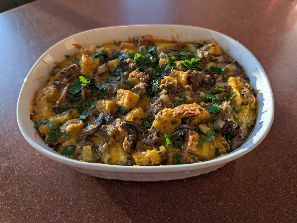 Brunch casserole fresh out of the oven with a little parsley on top