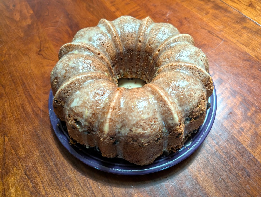 Whole-ass bundt coffee cake on a plate barely large enough to accommodate it