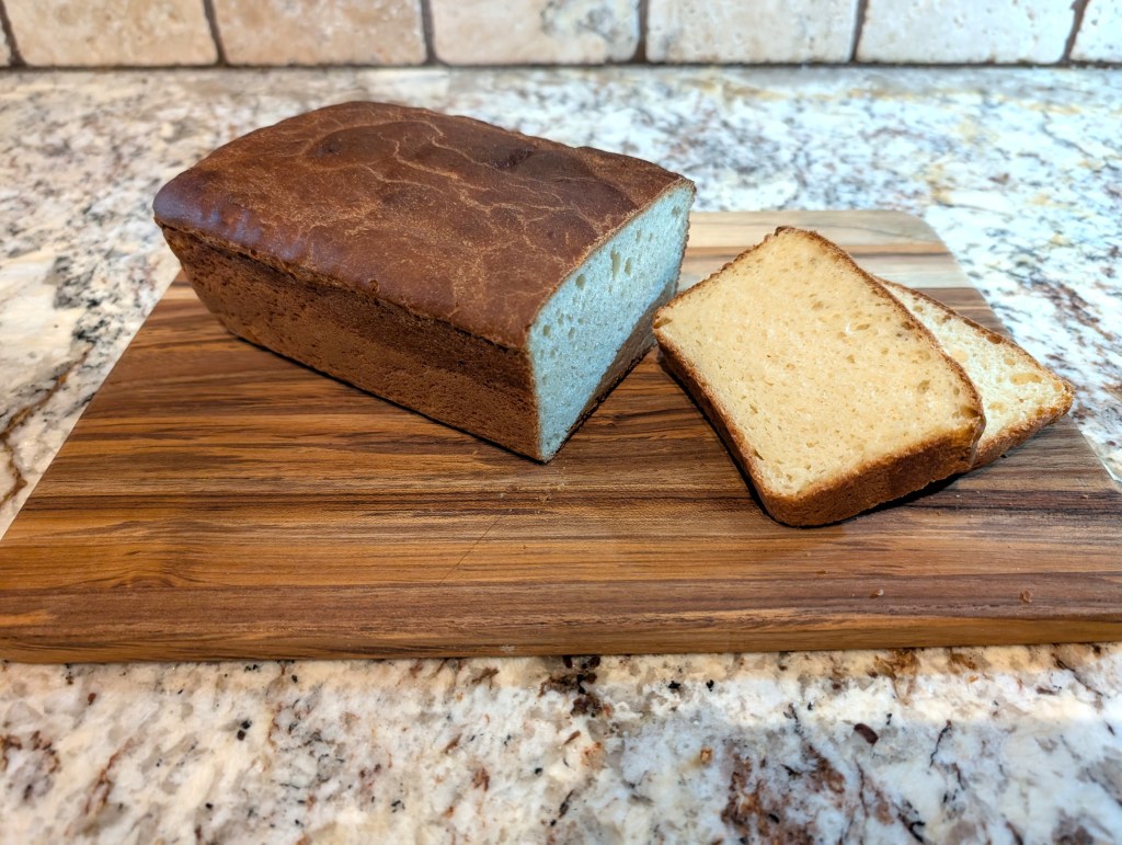 a loaf of bread masquerading as coffee cake, with two slices cut out