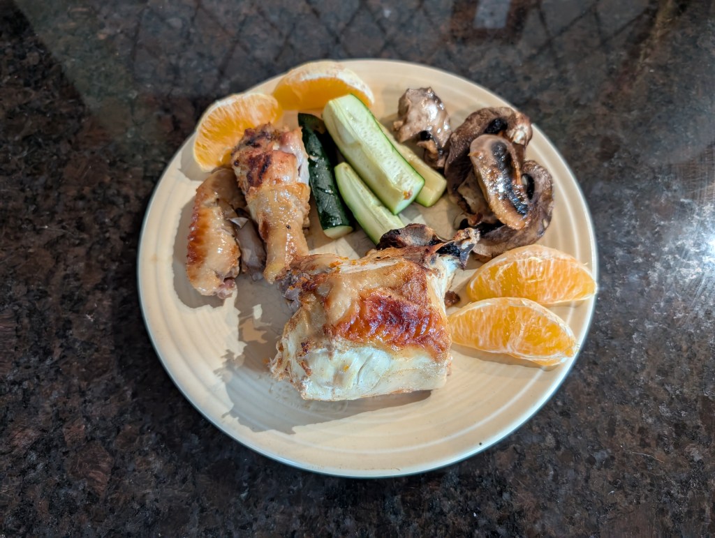 baked orange chicken with zucchini, mushrooms, and orange slices