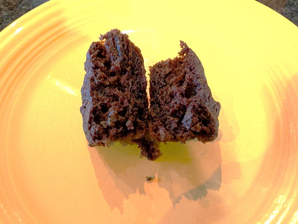 A muffin cut in half. No traces of zucchini can be seen.
