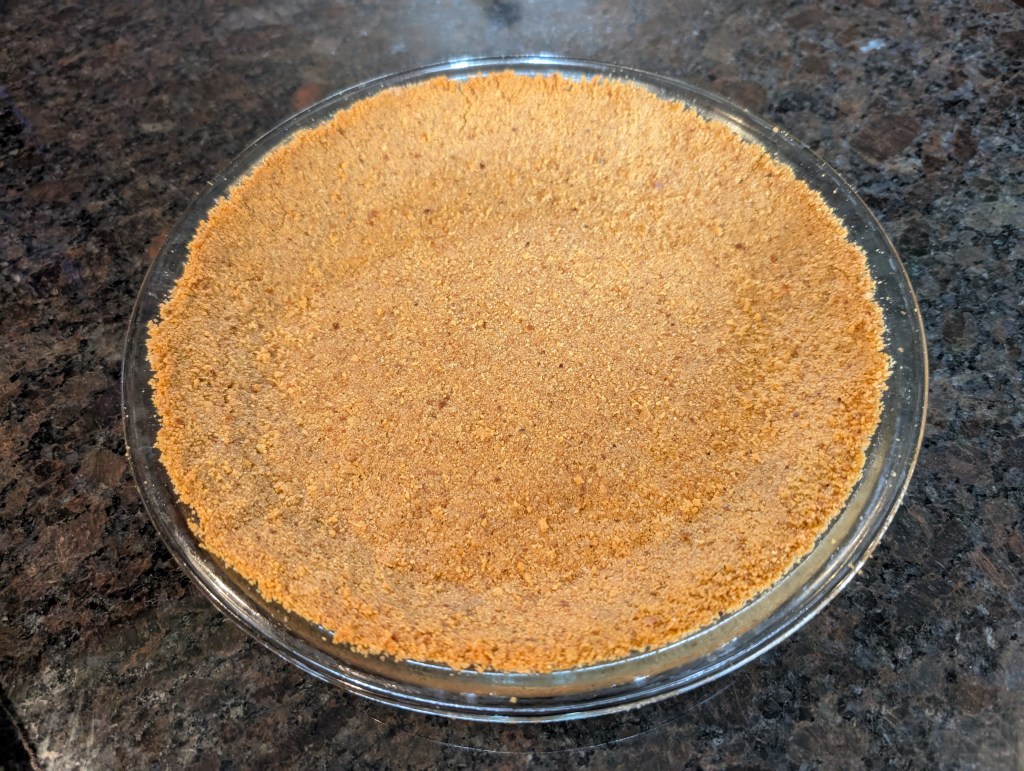 baked graham cracker pie crust before the filling goes in