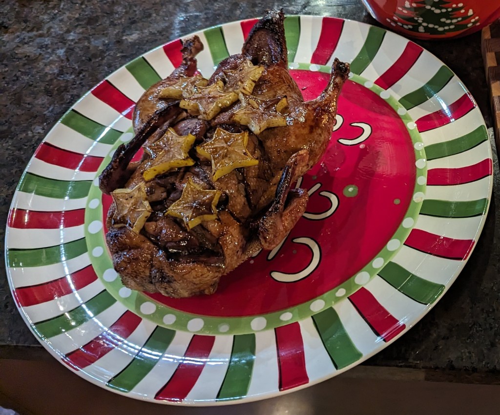 Roast duck glazed with starfruit on a Christmas platter