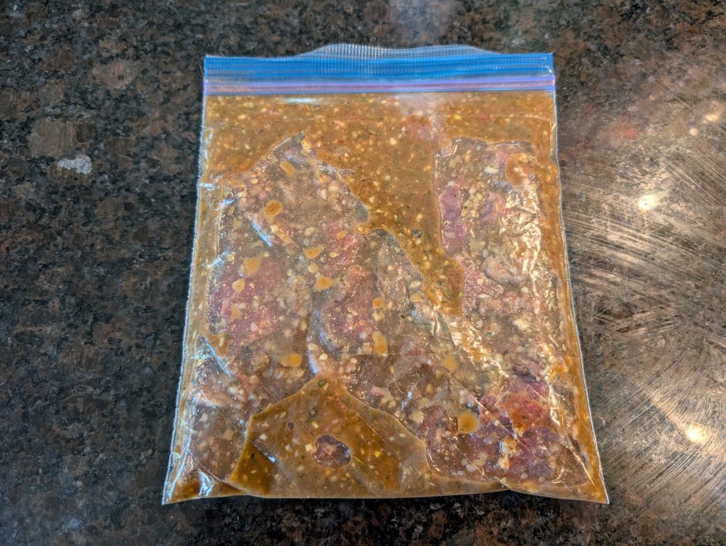 Cochinita pibil marinating beef in a zippered bag