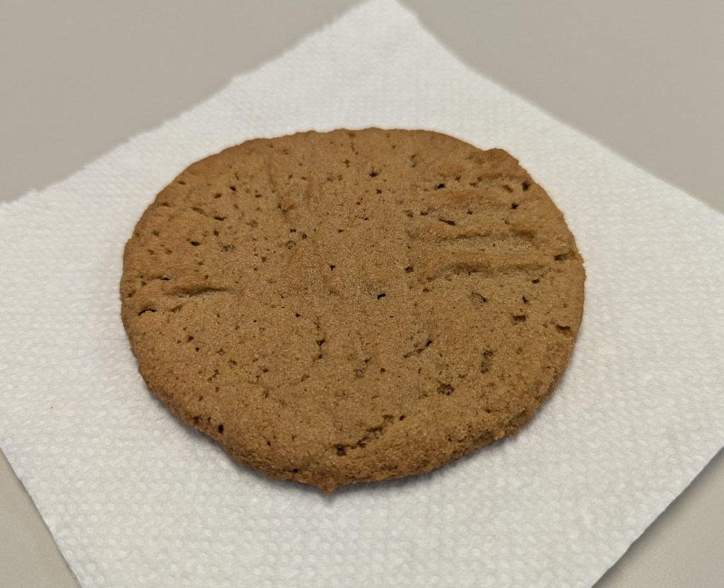 gluten-free peanut butter cookie on a paper napkin at my desk at work, because I forgot to stage a better photo at home