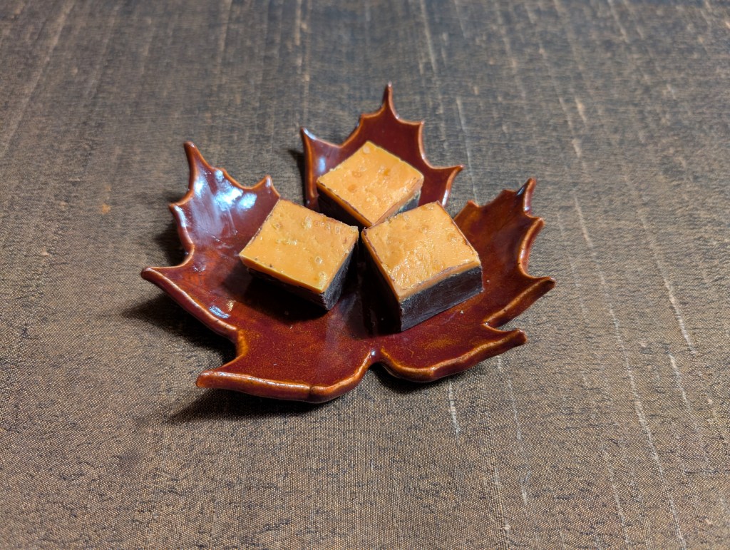 Salted caramel fudge on a small plate shaped like a maple leaf