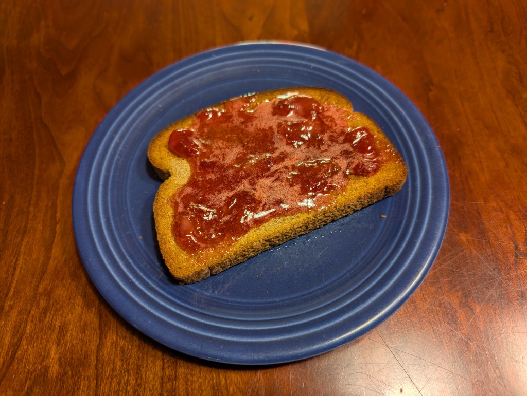Strawberry jam foam on a slice of toast