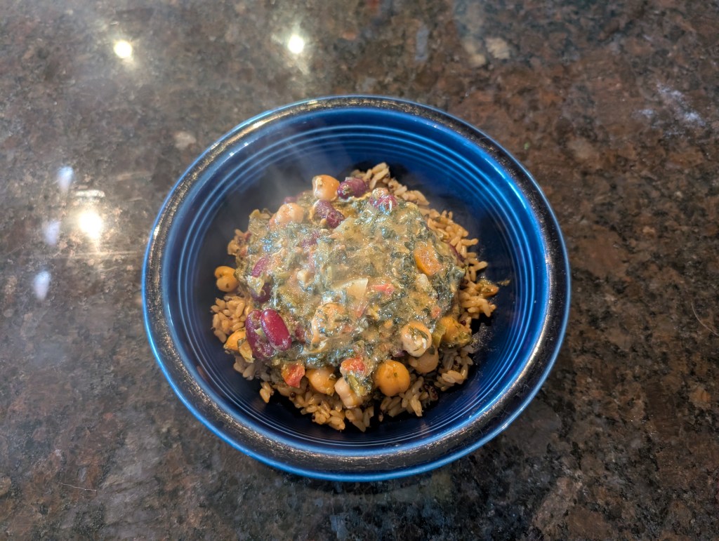 A steaming-hot bowl of struggle stew on a bed of brown rice