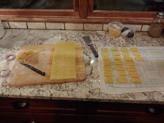 Springerle dough, half cut out, half remaining uncut on a cutting board