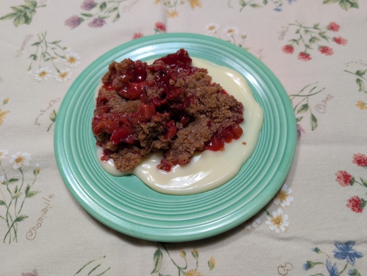 Strawberry Rhubarb Crumble with almond-flavored sweet cream sauce