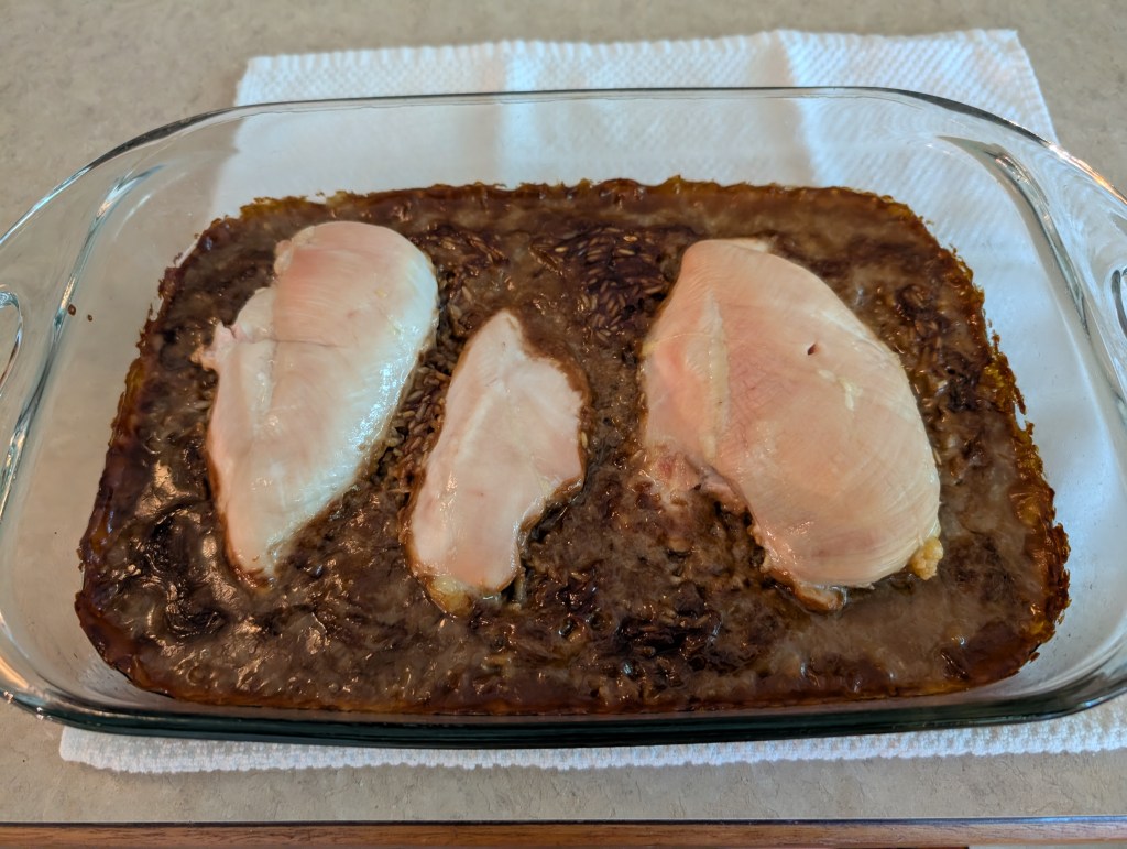 rice and chicken casserole in a glass casserole dish