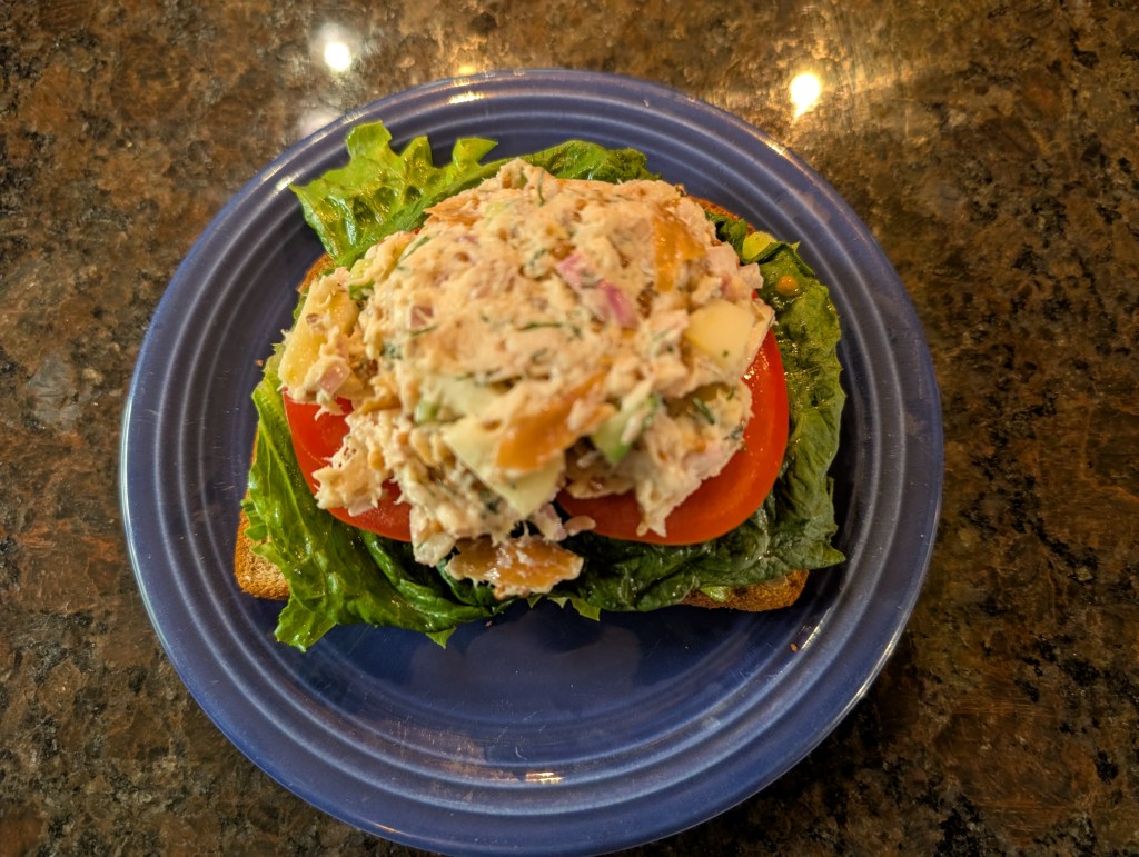 smoked trout salad on tomato, lettuce, avocado, and 12-grain bread