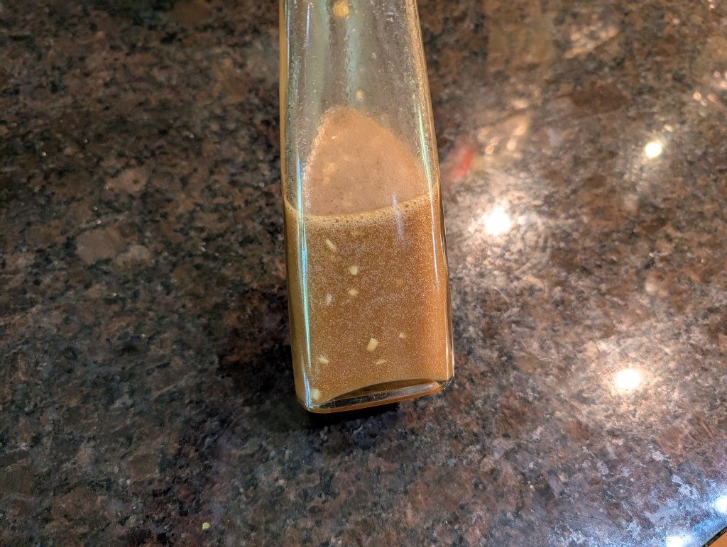 ginger salad dressing in a glass bottle