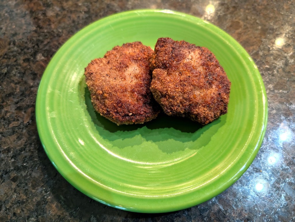 two cooked kotleti (patties) on a small plate