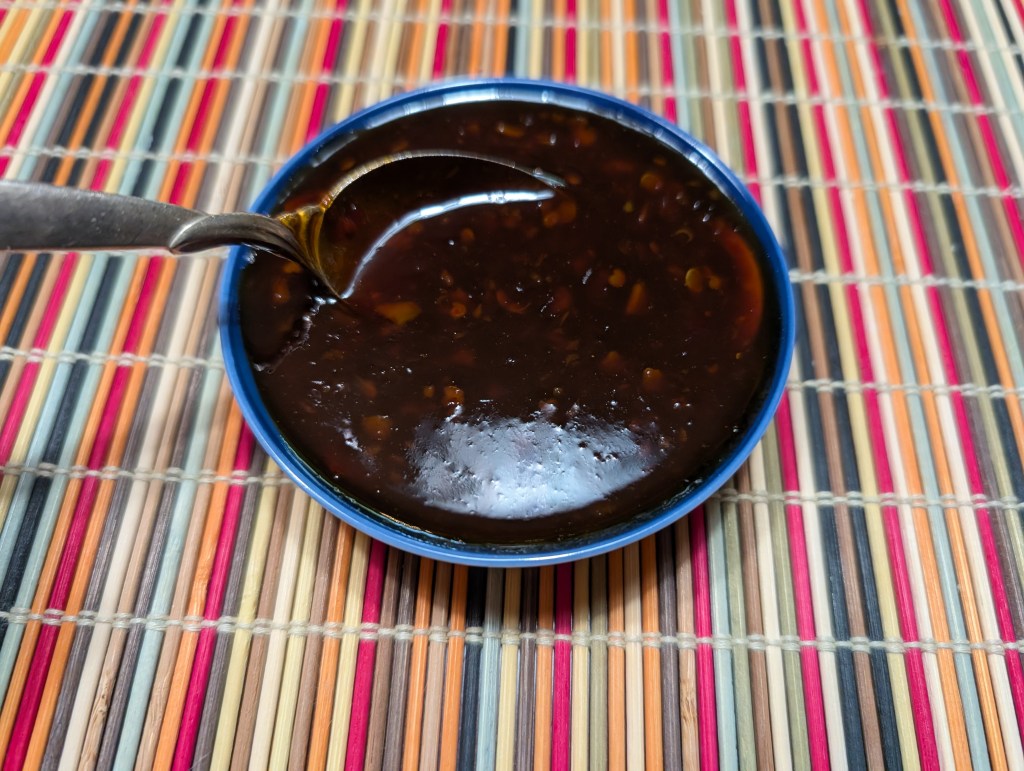 sweet chili pineapple sauce in a small bowl with a spoon