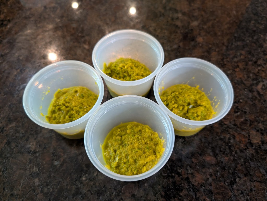 four small cups of green curry paste