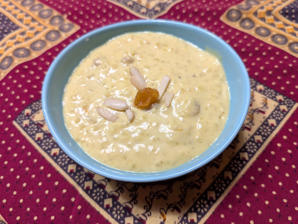 A bowl of rice pudding wit added raisins and almonds on top