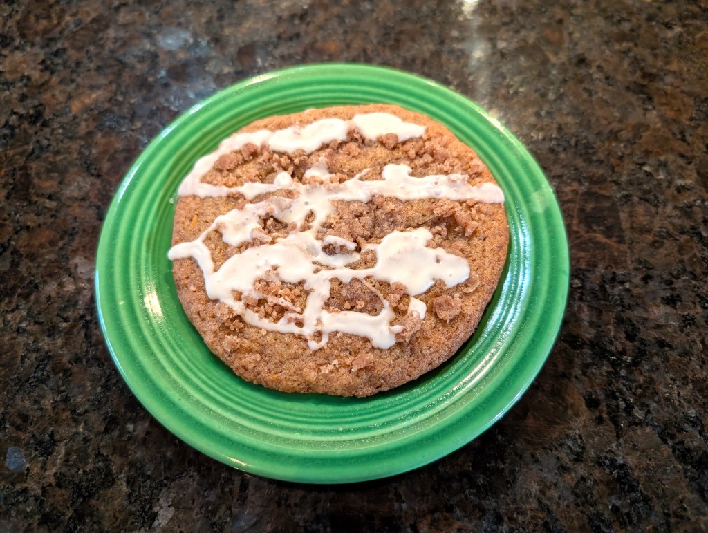 one big cookie on a small plate with drizzled icing that might have some unfortunate associations with the X-rated film industry.