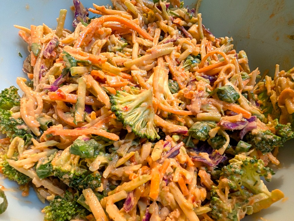 spicy peanut broccoli slaw in the mixing bowl