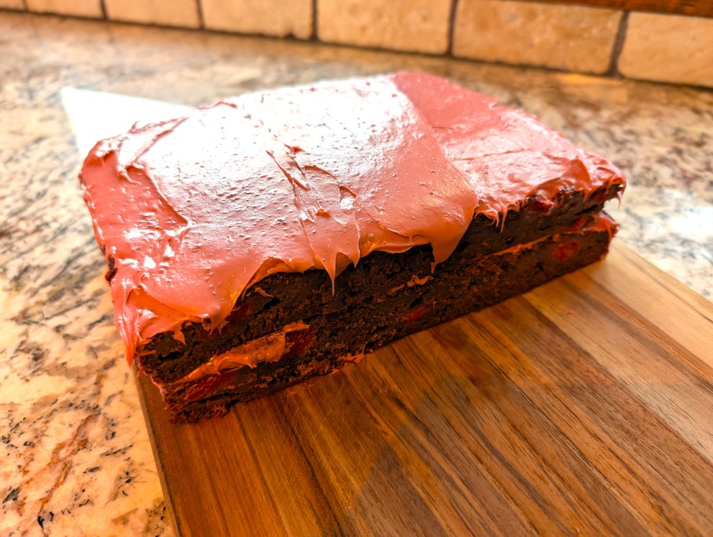 the cake, cut in half and stacked between layers of frosting