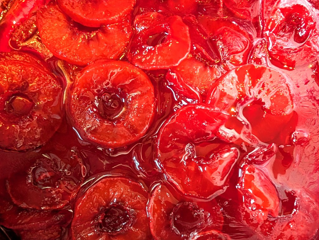 Close-up of red apple slices in the saucepan