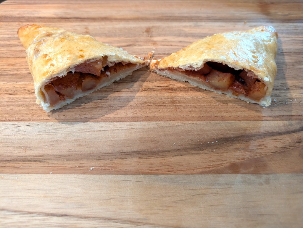apple turnover cut in half to show the filling inside