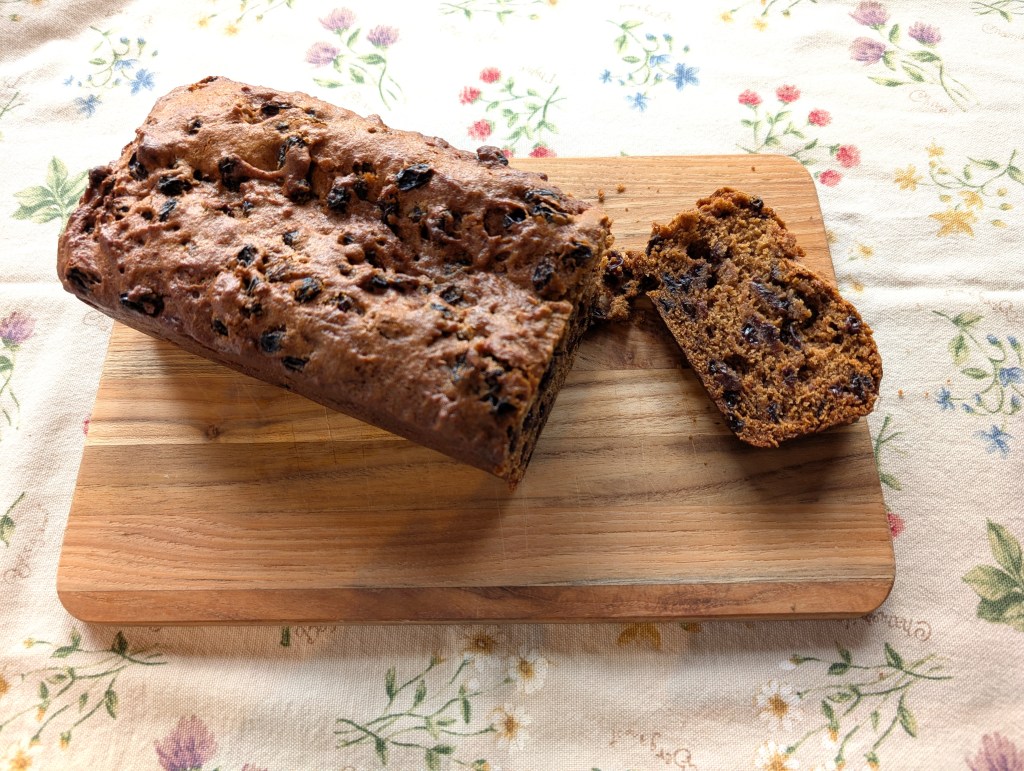 World War 1 cake on a cutting board with one slice cut from the rest