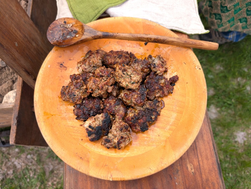fried sausage patties on a wooden plate